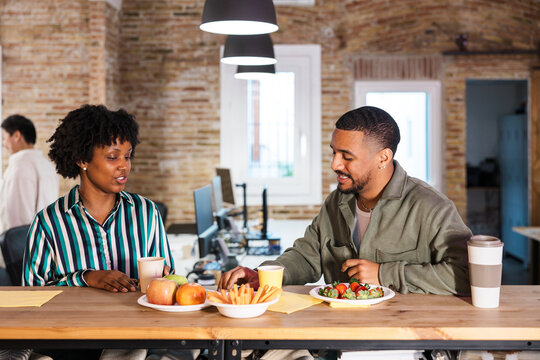 Office workers enjoying healthy breaktime meal together