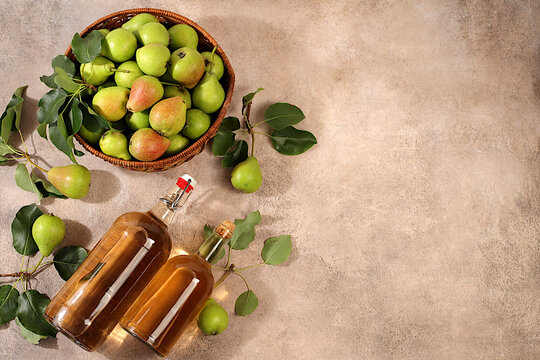 Pear cider with fruit in baskets, Thanksgiving decorations and country harvest, healthy natural food and home canning concept, long-term storage at home, banner for a screen, business card for a cafe