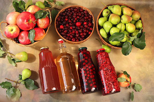 Apples, pears and cherries in baskets with bottles of cider, compote, and mulled wine, a Thanksgiving backdrop and a rustic harvest, concept of healthy natural food and home canning,