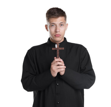 Portrait of young priest with wooden cross on white background