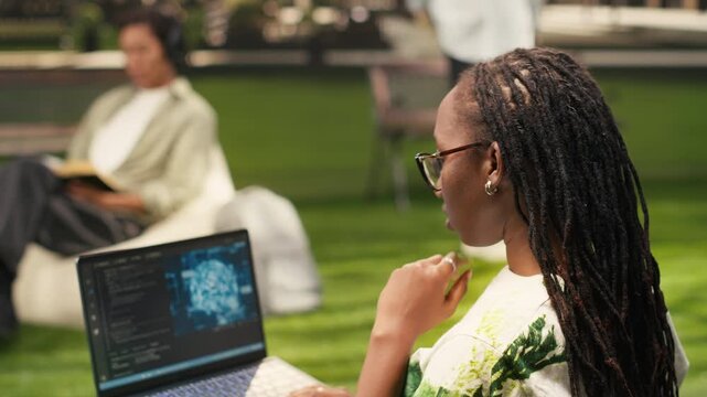 The engineering student uses AI neural networks on a laptop screen, with programming language in a terminal window with machine learning script, during outdoor learning, for campus study.