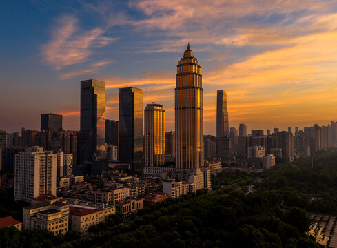 Wuhan CBD skyline illuminated by a dramatic fiery sunrise. These brilliant burning clouds above towering skyscrapers symbolize a blazing, prosperous economy and the dawn of a dynamic financial future	