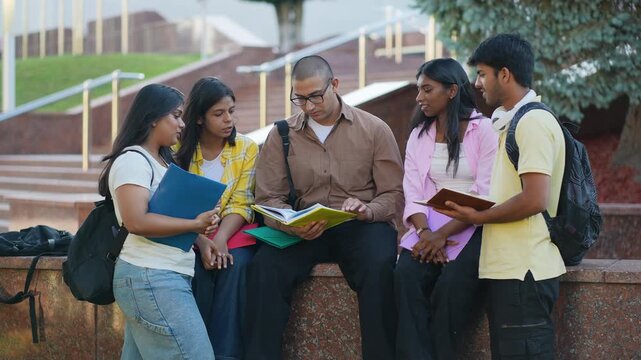 Indian university students discussing school project outdoors