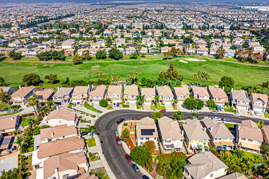 Fontana, California, CA October 15, 2024: High Aerial City Drone View toward Sierra Lakes Golf Club, Sierra Ave, Citrus Ave, Fwy 210 with Homes, Houses, Townhomes, Streets, Roads, Buildings, Mountain
