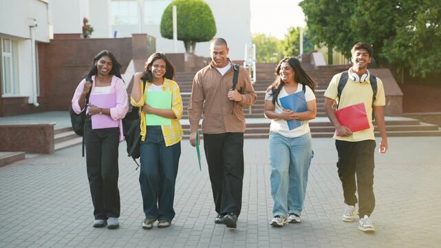 Group of diverse college students walking on campus together