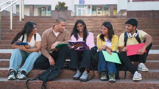 Group of indian students studying together on campus steps