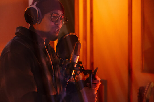 Young musician singing song in a creative music studio