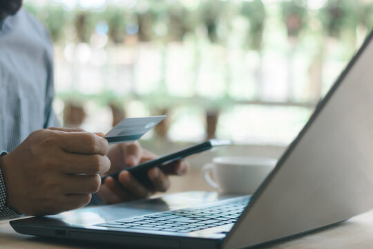 Online shopping and digital payment concept featuring a consumer using a laptop, smartphone, and credit card, representing ecommerce, mobile banking, secure transactions, and modern finance.