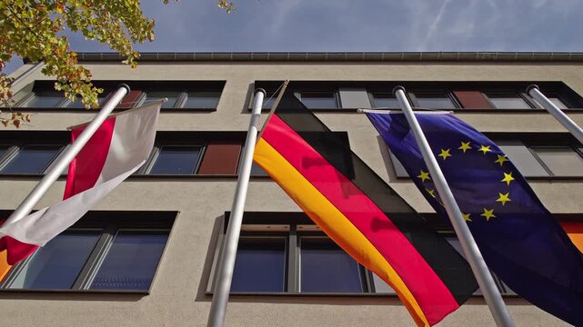 Austrian, German and European Union Flags Outside Modern Building