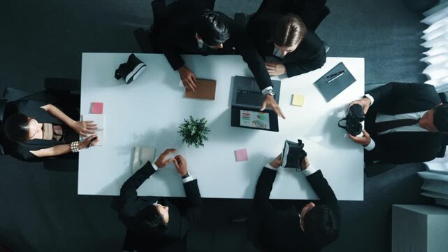 Top view of professional businessman give vr headset to diverse investors while young businesswoman looking at data analysis or marketing statistic on laptop and prepare for data sharing. Directorate.