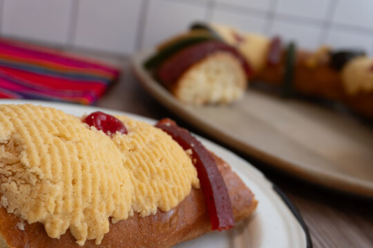 A part of the "Rosca de Reyes" or Epiphany bread, placed on a wooden table.