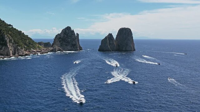 Capri Island Faraglioni Rocks with Tourist Boats on Blue Mediterranean Sea