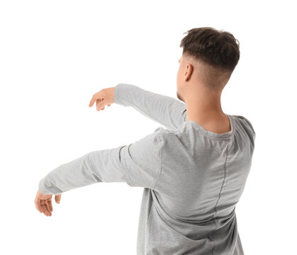 Male sleepwalker in pajamas on white background, back view