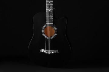 Fototapeta premium Acoustic guitar on black background, closeup
