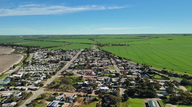 Port Clinton, Yorke Peninsula, South Australia &ndash; 4K aerial drone view of tidal beach, tidal flats, coastal township, holiday homes, residential estates, Gulf St Vincent shoreline, farmland, wetland.