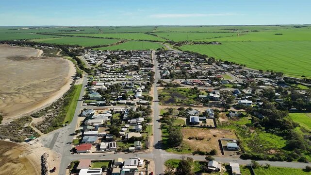 Port Clinton, Yorke Peninsula, South Australia &ndash; 4K aerial drone view of tidal beach, tidal flats, coastal township, holiday homes, residential estates, Gulf St Vincent shoreline, farmland, wetland.