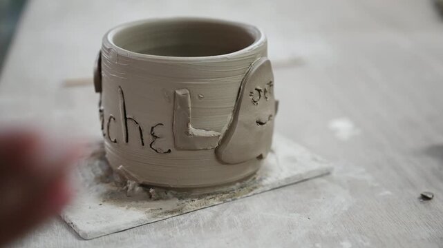 Decorating handmade pottery with clay ornaments and reliefs