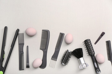 Fototapeta premium Easter eggs and hairdressing accessories on white background