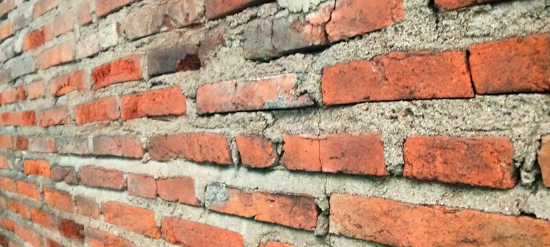 Angled view of a dark red brick wall texture