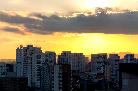 Sunset from the building's terrace, showing buildings and the cantareira mountain range in the city of Sao Paulo.