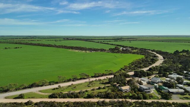 Port Julia, Yorke Peninsula, South Australia &ndash; 4K aerial drone view of jetty, sheltered beach, limestone cliffs, coastal township and Gulf St Vincent, beachfront holiday homes, surrounding farmland.