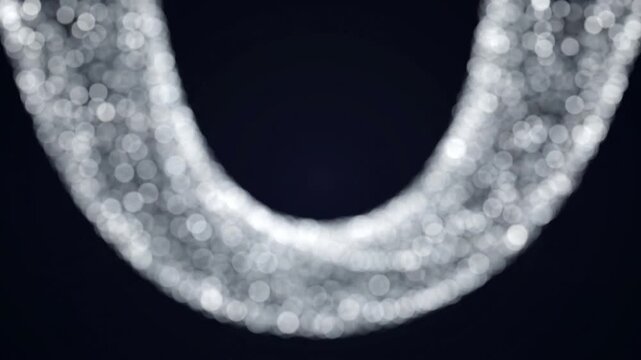 見えないU字磁石の磁力線に沿って銀色の円形ボケがアーチを描く、抽象的な光のトポロジー映像。