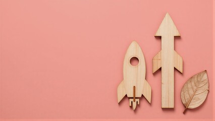 Naklejka premium Wooden rocket and arrow on pink background, symbolizing growth and nature.
