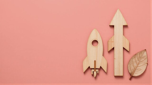 Wooden rocket and arrow on pink background, symbolizing growth and nature.