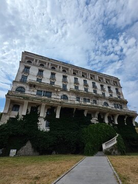 Historic Palace Hotel building covered with ivy in Constanta, Romania