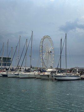 Sailboats and Ferris wheel at Tomis Marina in Constanta, Romania