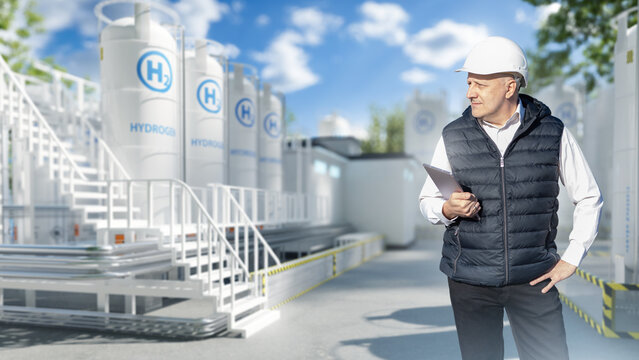 Hydrogen production. Engineer inspects hydrogen storage tanks with a tablet at a clean energy facility, monitoring equipment, safety systems and plant operations.
