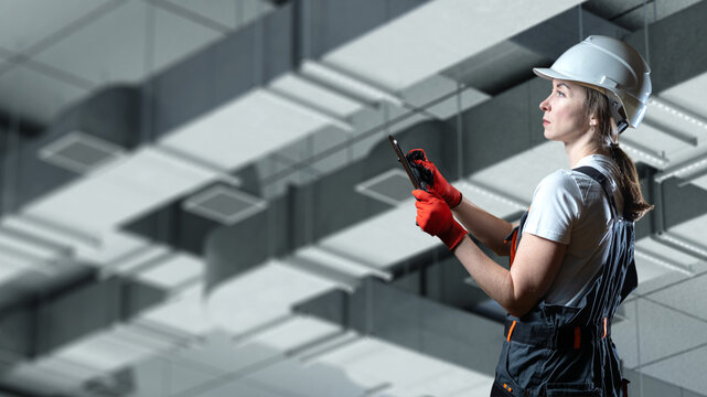 HVAC installation. Female engineer inspects ventilation ducts with a tablet during HVAC system installation, checking air distribution, equipment and technical compliance.