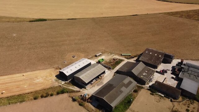 Flight over dangerously dry harvested fields and farm in Wiltshire.  High summer
