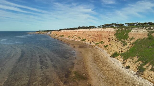 Port Julia, Yorke Peninsula, South Australia &ndash; 4K aerial drone view of red limestone cliffs, old coast road, surrounding farmland, and Gulf St Vincent.