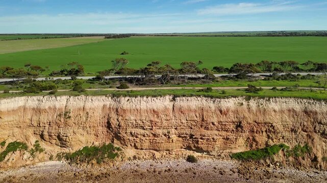 Port Julia, Yorke Peninsula, South Australia &ndash; 4K aerial drone view of red limestone cliffs, old coast road, surrounding farmland, and Gulf St Vincent.