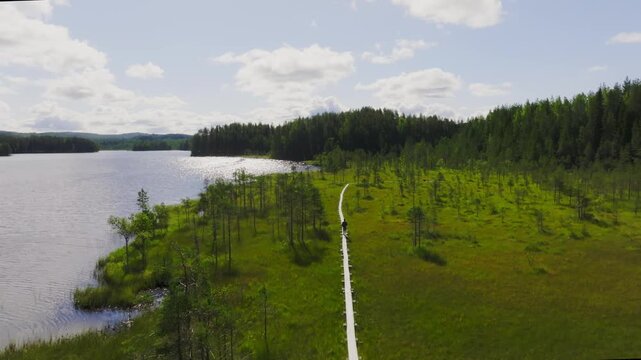 Drone view of a man walking on the wooden duckboards in Koli National Park