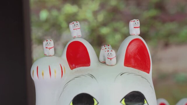 Big Maneki Neko lucky cat statue at Gotokuji Temple in Tokyo, Japan, showcasing one of the country's most famous symbols of fortune, prosperity, and traditional Japanese culture.