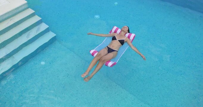 Woman Relaxing in Luxury Pool in Greece, Aerial View