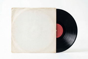 Naklejka premium Classic black vinyl record partially slid out of a plain aged white paper sleeve