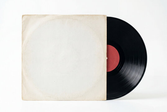 Classic black vinyl record partially slid out of a plain aged white paper sleeve