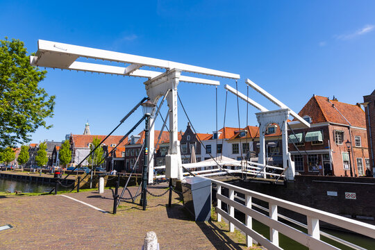White drawbridge opening on the canal in Enkhuizen