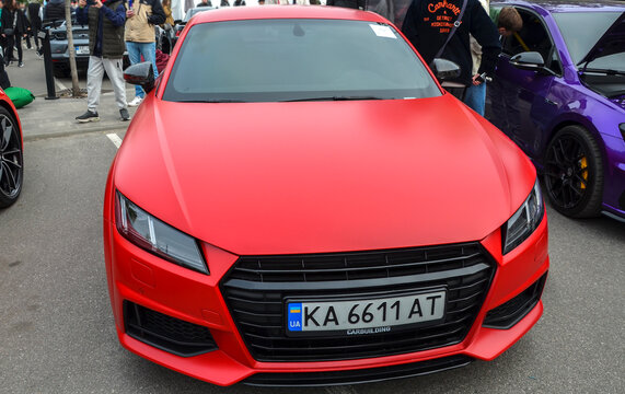Modern matte red Audi TT coupe icon of European design and tuning culture showcasing aggressive gloss black grille, angular LED headlights and sculpted performance stance