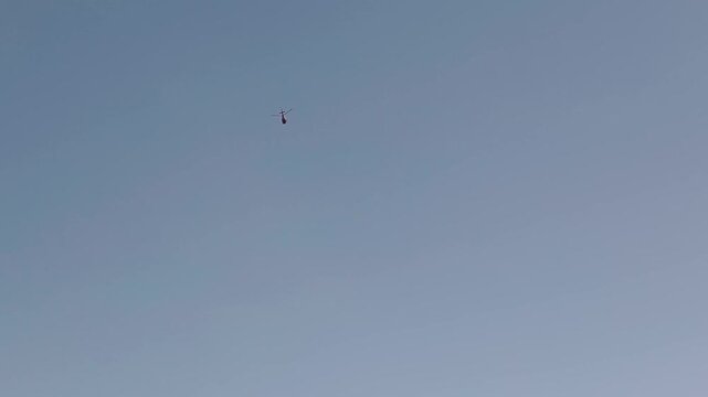 Aircraft flying above Lake Paranoa in Brasilia, Federal District, Brazil, isolated against a clear blue sky during a smooth aerial tracking shot, drone tracking.