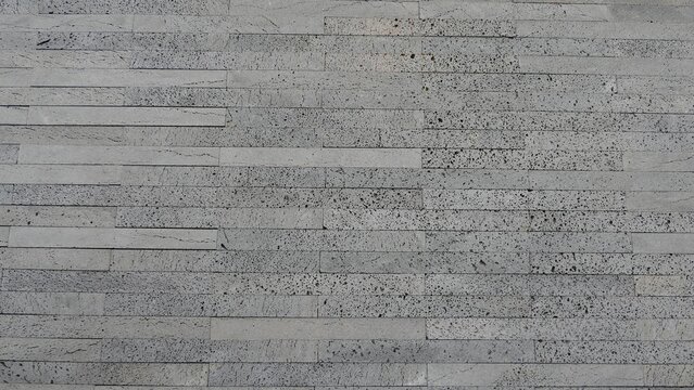 Gray Stone Cladding Wall with Porous Surface Texture