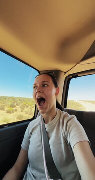 Joyful Woman on Road Trip Through Scenic Arizona Desert Landscape