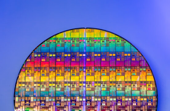 wafer silicon monocrystalline  with microchips after photolithography etching manufacturing reflecting different colors used in fabrication of electronic integrated circuits.