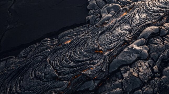 Macro view of flowing pahoehoe lava contrasting with warm subsurface magma energy