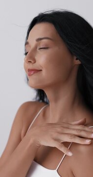 Close-Up Woman Touching Face and Neck in Beauty Studio