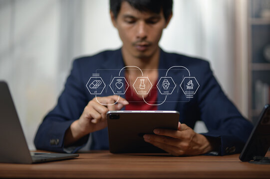 Young Man Using Tablet for Business Technology with Digital Creative Icons