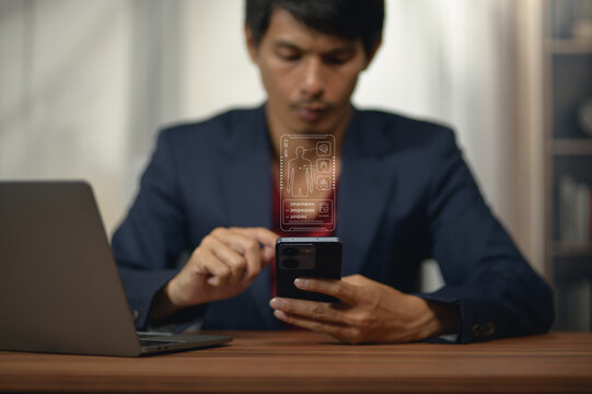 Young Man Using Smartphone with Holographic Tech at Home Desk
